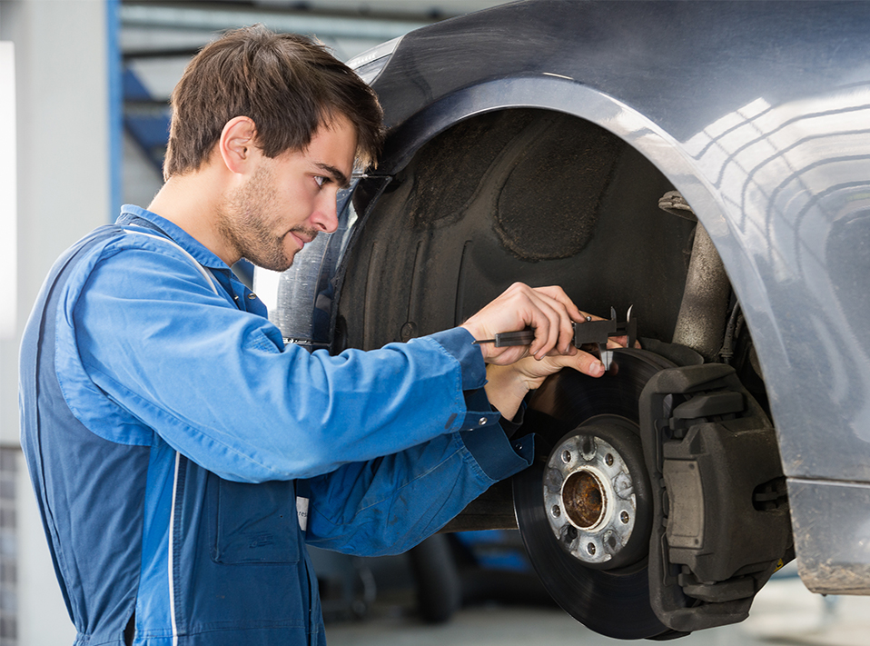 Mechanic repairing a vehicles brakes - Brakes Long Eaton