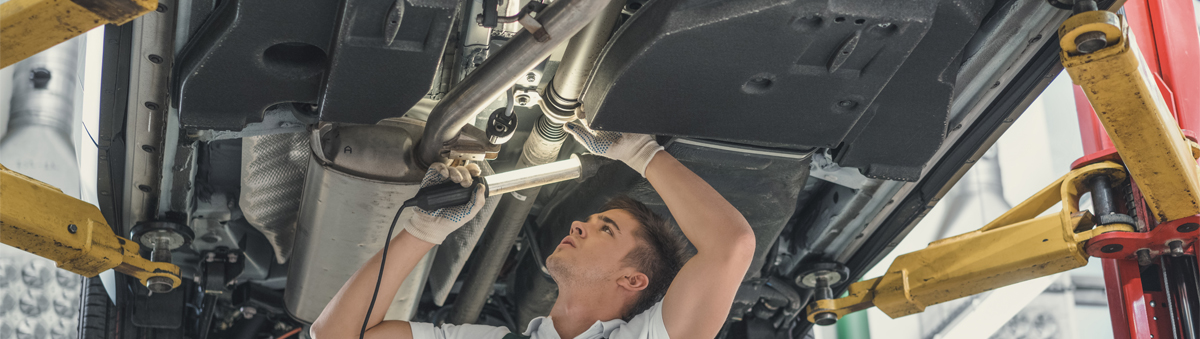 Mechanic doing an MOT inspection on a vehicle - MOT Long Eaton